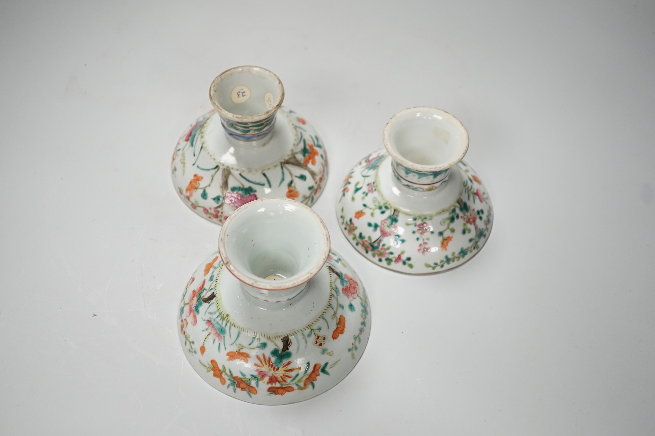 Three 19th century Chinese famille rose pedestal stem bowls, each painted with flowers and foliage, 9.5cm tall